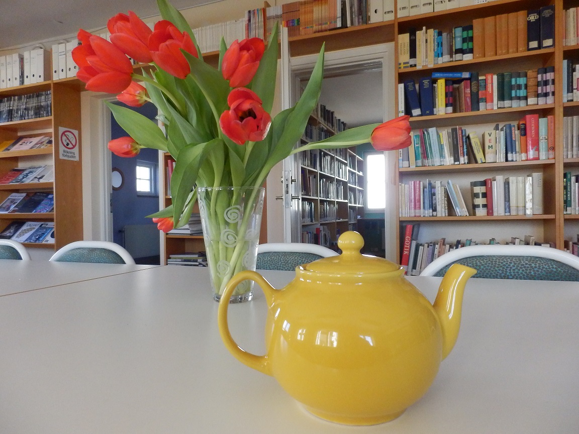 Library of Baltic Centre for Writers and Translators with many books, tulips and teapot